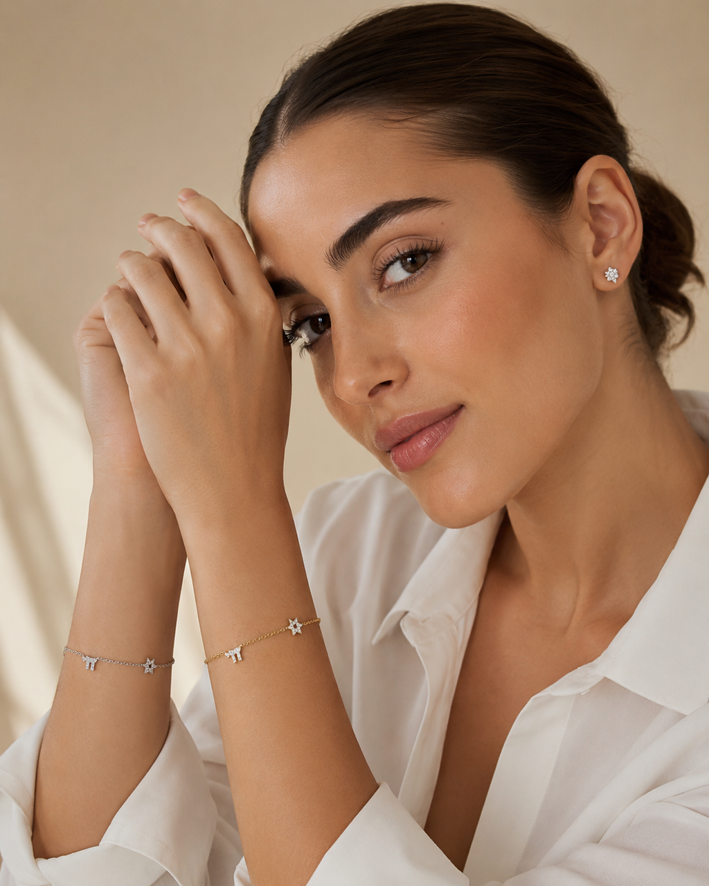Model wearing the Gold Tone and Silver Tone Pavé Trio Bracelets featuring Star of David, Hamsa, and Chai pavé charms.
