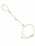 Gold tone Pavé Trio Hand Chain with Hamsa, Chai, and Star of David charms on a white background.