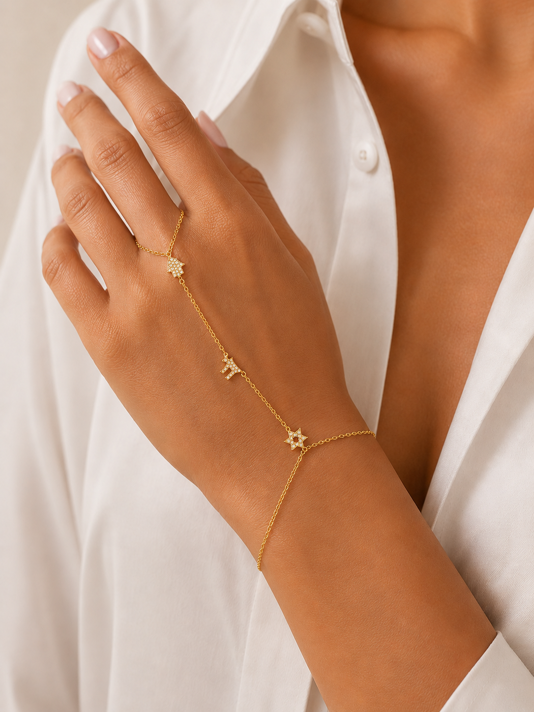 Model Gold: Model wearing the gold tone Pavé Trio Hand Chain.
