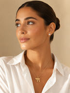 Model wearing the gold tone Perlée Chai Necklace.