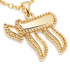 Close-up of the gold tone Perlée Chai pendant with bead-like detailing.