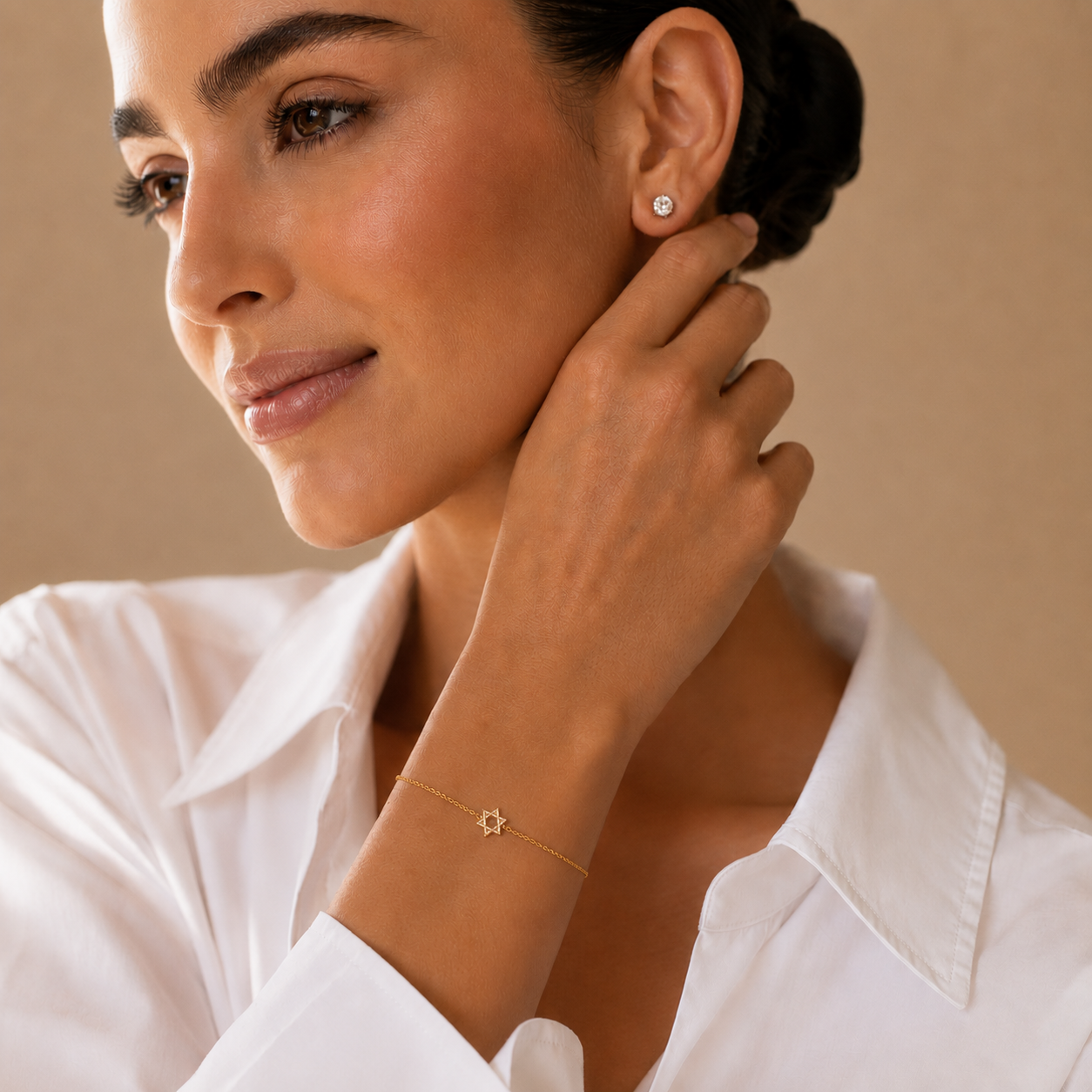 Model wearing the gold tone Petite Magen David Bracelet.