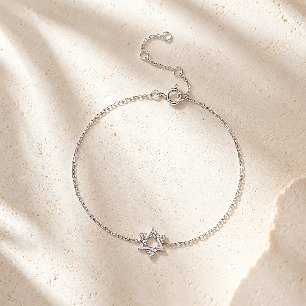Silver tone Petite Magen David Bracelet styled on a neutral stone surface.