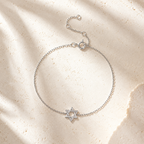 Silver tone Petite Magen David Bracelet styled on a neutral stone surface.