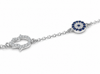 Close-up of the Protection Bracelet pavé Hamsa and Evil Eye charms in Sterling Silver.