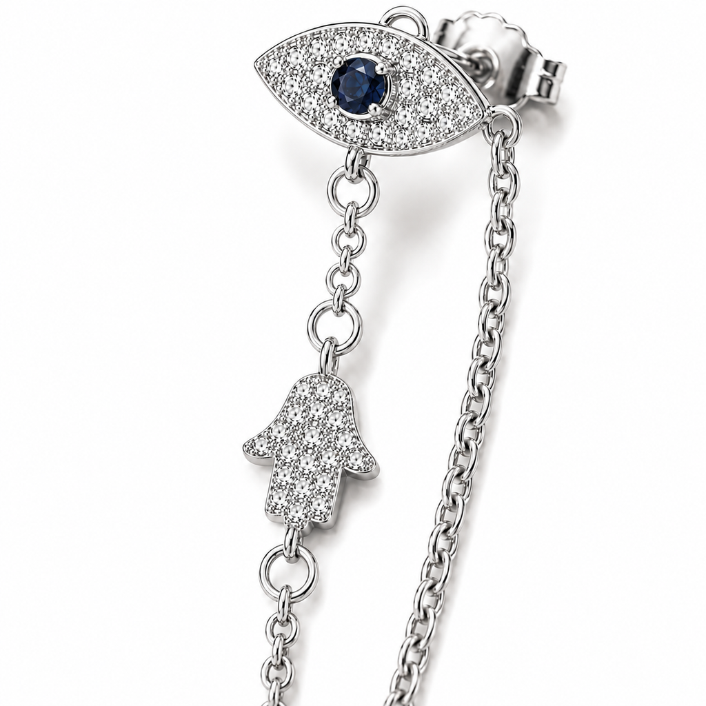 Close-up of the Silver Tone Protection Drop Chain Earrings featuring pavé Evil Eye studs and Hamsa charms connected by delicate chains.