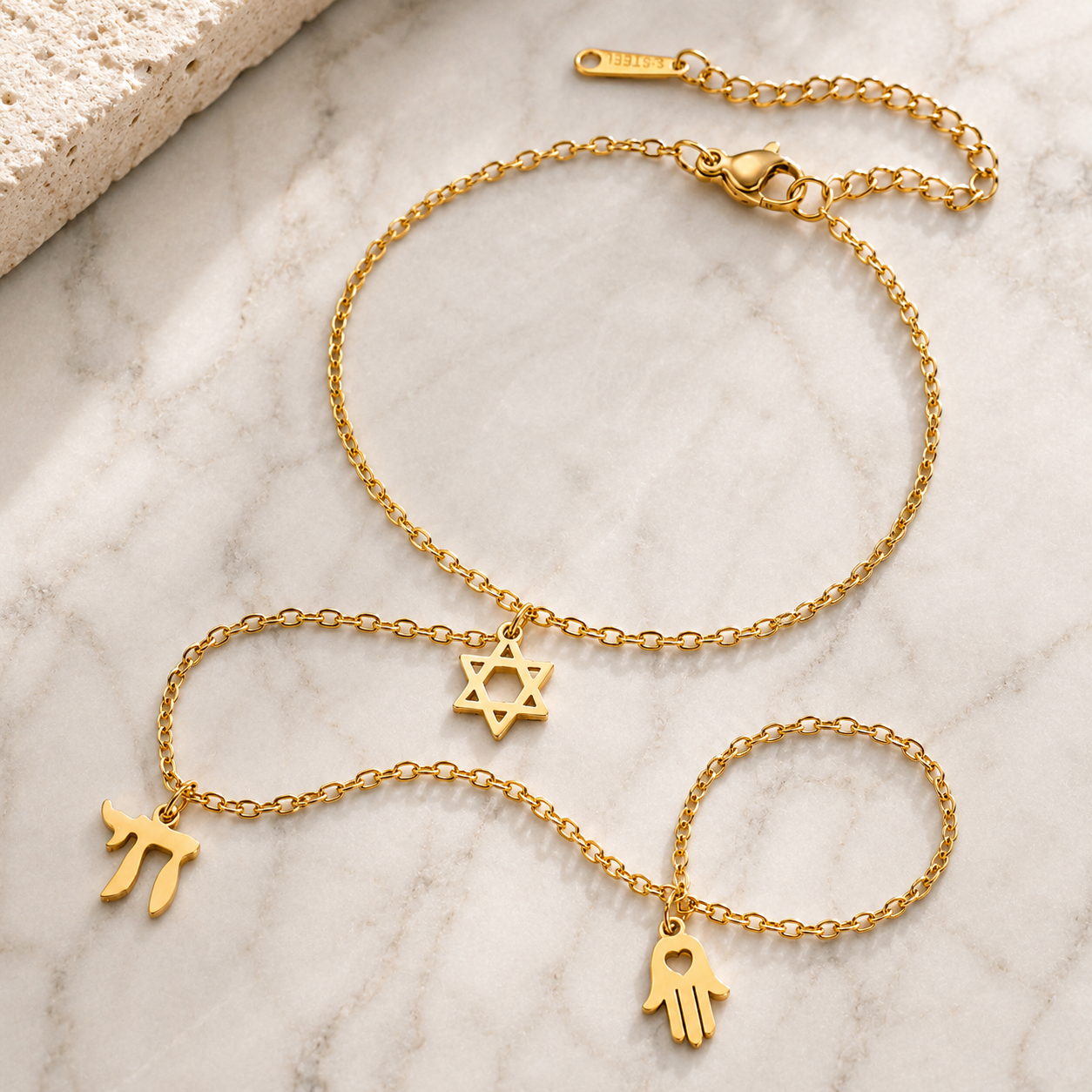 Gold tone Protection • Identity • Life Hand Chain styled on a neutral stone surface.
