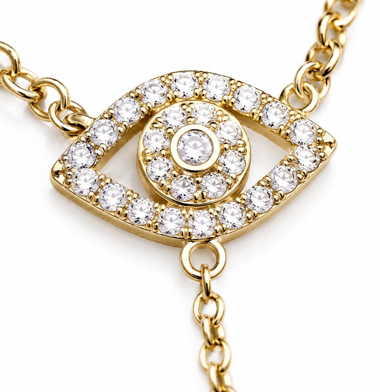 Close-up of the pavé Evil Eye charm on the gold tone Protection Lariat Necklace.