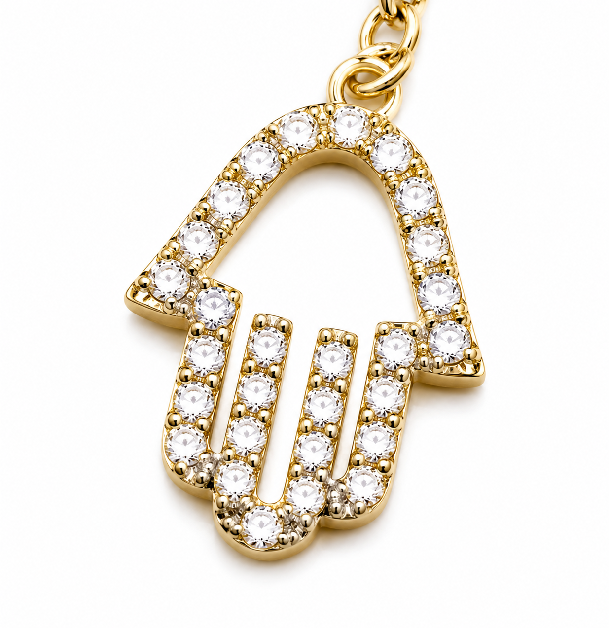 Close-up of the pavé Hamsa charm on the gold tone Protection Lariat Necklace.