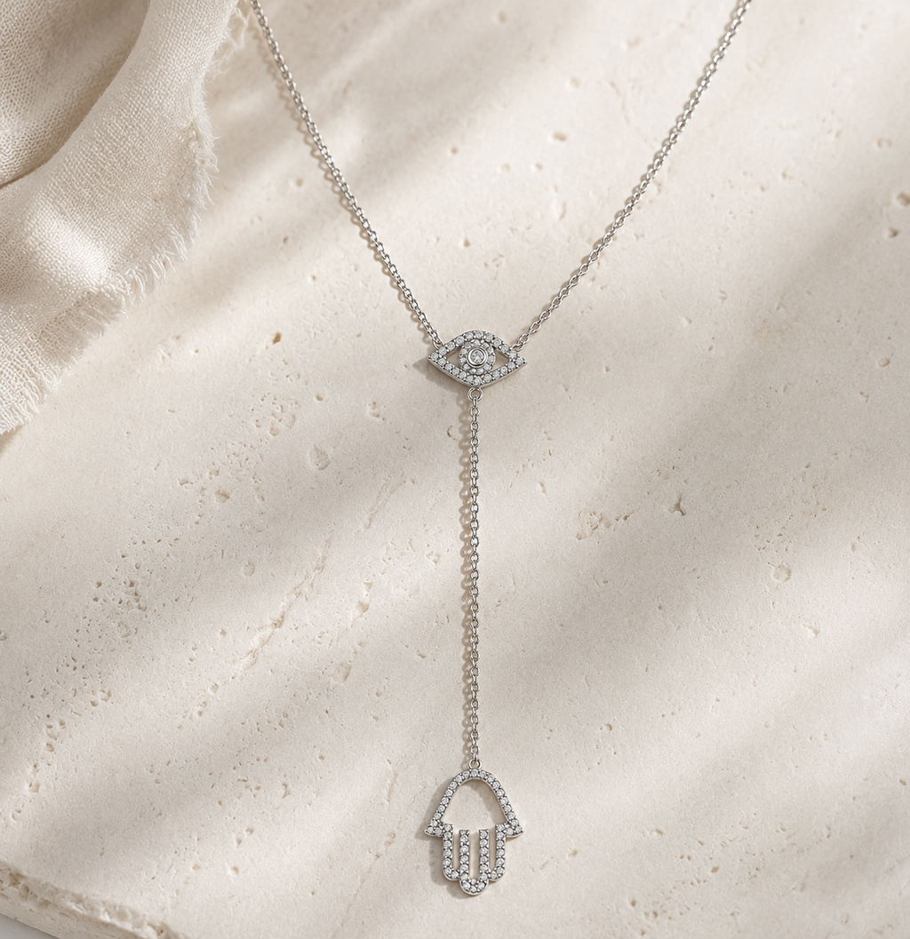 Silver tone Protection Lariat Necklace styled on a natural stone surface.