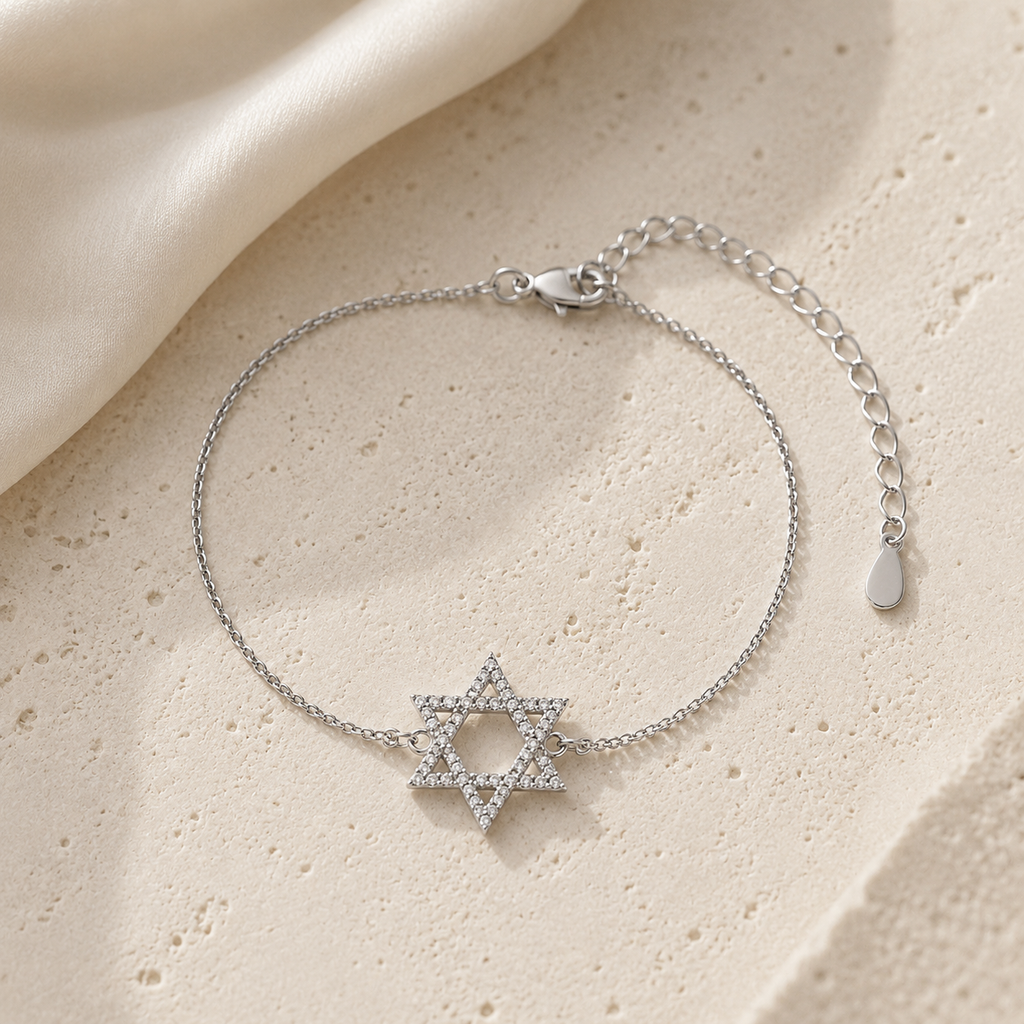 Silver Tone Star of David Bracelet displayed on a luxury neutral stone surface.