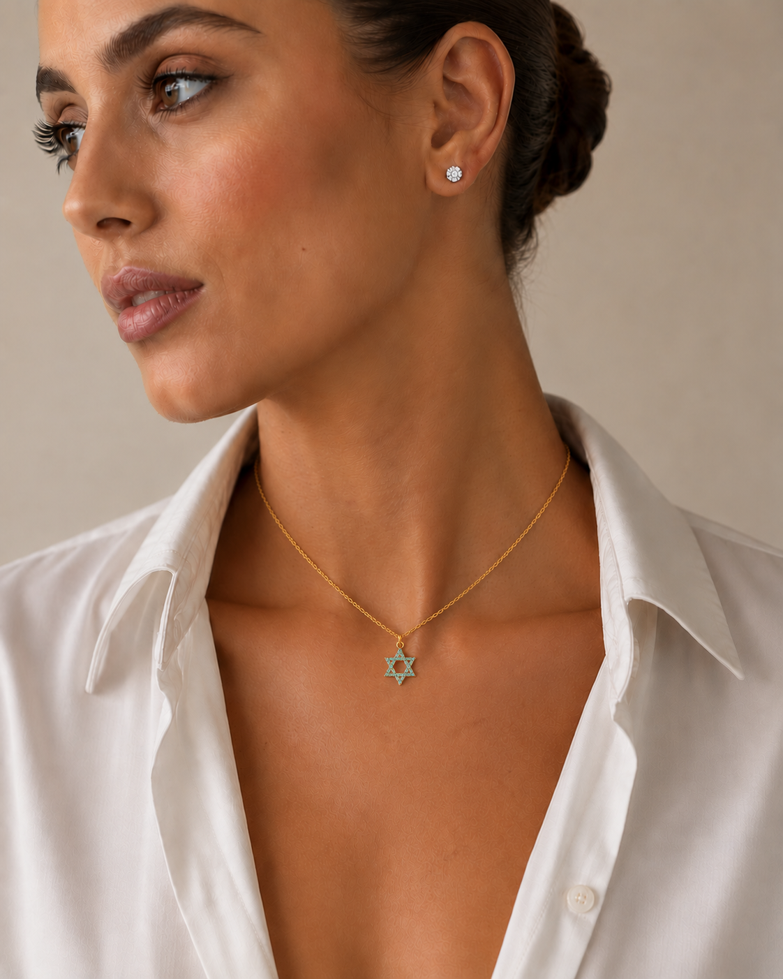 Woman wearing the Turquoise Star of David Necklace in gold tone.